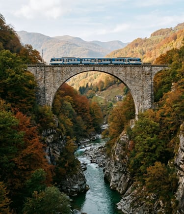 Blue Centovalli Express train on stone arch bridge above river gorge with colorful autumn forest