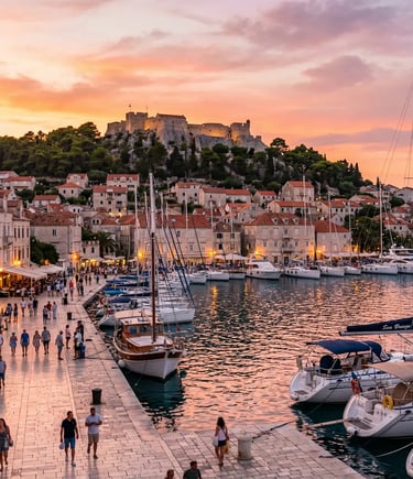 Hvar Town harbor at golden hour with Spanish Fortress and sailboats on island tour