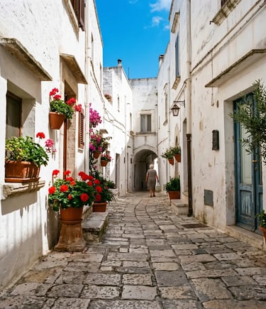 Elderly woman walking cobblestone street in Ostuni historic center Puglia Italy