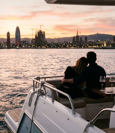 Couple watching Barcelona skyline at sunset from yacht stern with wine glasses