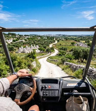 POV buggy driver on white gravel trail with trulli and olive groves ahead