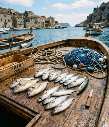 Sea bream and mackerel catch on wooden boat deck with fishing nets, Croatian harbour behind
