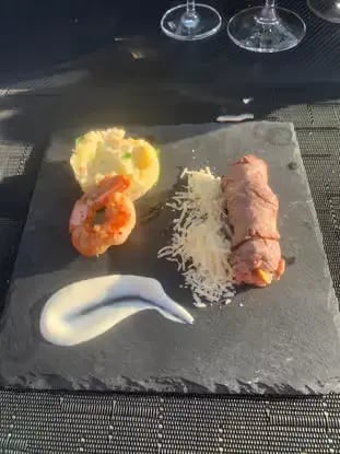 Prawn and stuffed meat main course served on slate at sky dining Dubrovnik