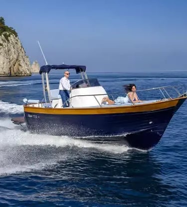 Private speedboat cruising at speed along the Ligurian coastline on the Mediterranean Sea