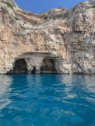 Blue Cave entrance on Biševo Island with limestone cliffs and bright blue Adriatic Sea