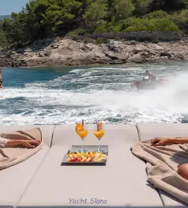  Guests on Gulet stern sunbathing pad watching water sports in a sheltered Croatian bay
