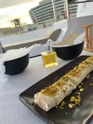 Gourmet pistachio dessert served on deck during Barcelona Mediterranean sailing tour