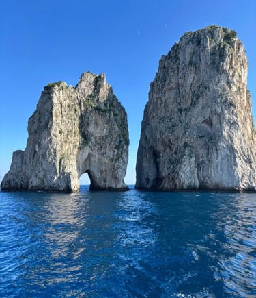 Faraglioni Rocks of Capri rising from deep turquoise Mediterranean water under a clear blue sky