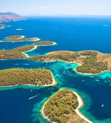 Aerial view of Pakleni Islands archipelago near Hvar with turquoise Adriatic sea and green coves