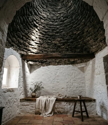 Dry-stone conical dome ceiling inside authentic Alberobello trullo with whitewashed walls and wood bench.