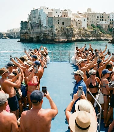 Packed group tour boat with dozens of tourists raising phones in front of Polignano cliffs