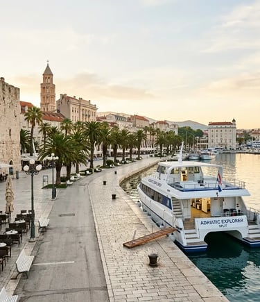 Tour boat docked at Split Riva promenade with Diocletian's Palace bell tower at sunrise