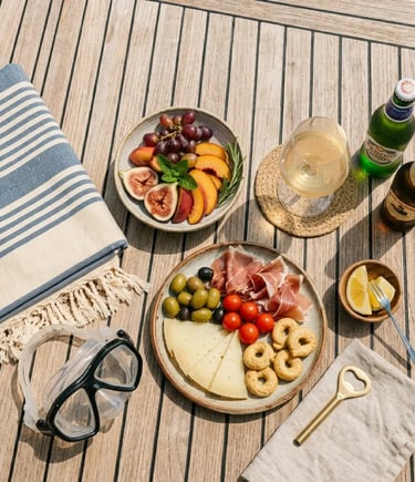 Local snacks wine beer and snorkeling equipment on teak yacht deck Amalfi charter