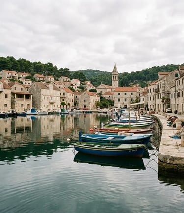 Colorful fishing boats moored in calm Milna harbor with stone buildings on Brač island