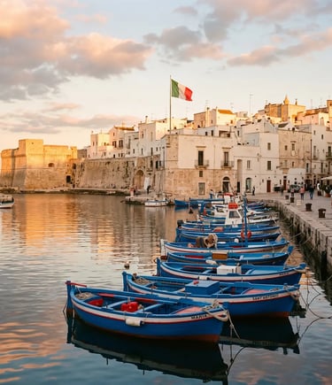  Traditional blue fishing boats moored in Monopoli old port with castle and white town at golden hour