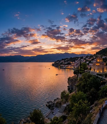 Panoramic sunset over Lake Ohrid with illuminated medieval church on rocky cliff