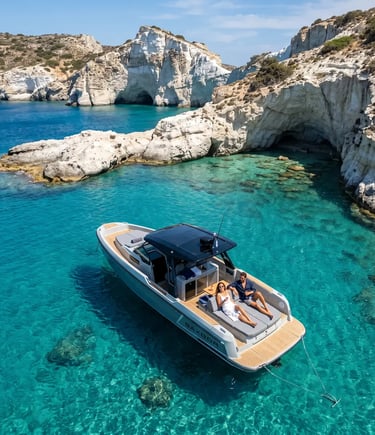 Couple relaxing on Saxdor 320 boat anchored in turquoise waters near Kleftiko white cliffs Milos