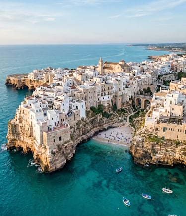 Polignano a Mare white buildings on limestone cliffs above turquoise Adriatic Sea, Puglia