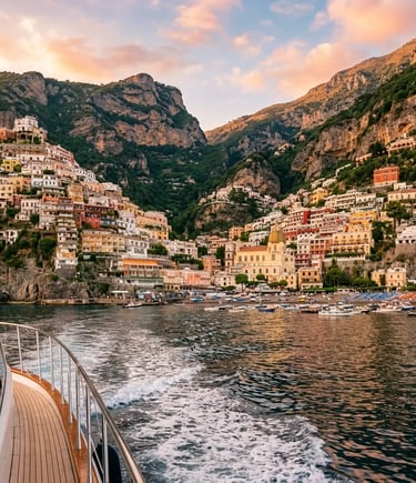 Positano's pastel hillside buildings viewed from a boat deck at golden hour
