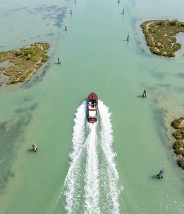 Aerial view of Riva Aquariva cutting through the Venetian Lagoon between marshy islands