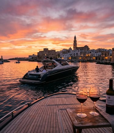 Luxury boat at sunset in Monopoli harbor with Primitivo wine glasses and Puglia skyline view