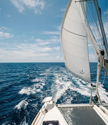 Catamaran under full sail crossing open blue Mediterranean sea near Menorca