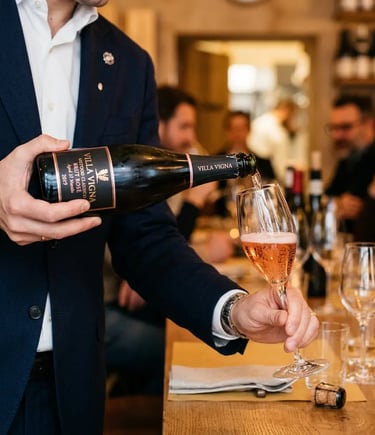 Sommelier pouring 32-month aged Metodo Classico Brut Rosé at Bari wine tasting
