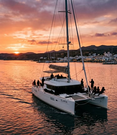Catamaran sailing back to Adamas port in Milos under orange sunset sky