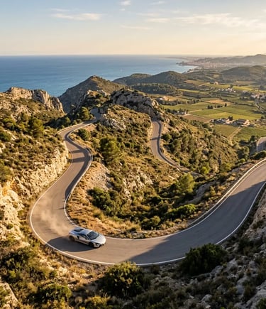 Supercar driving a winding coastal road from Barcelona toward El Penedès wine region