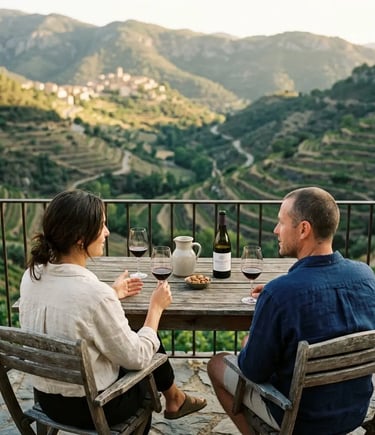 Couple tasting red wine on terrace overlooking terraced vineyards in Gratallops