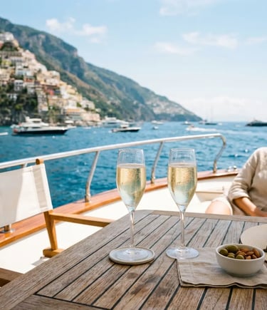 Two glasses of chilled Prosecco on a teak yacht deck overlooking the Amalfi Coast