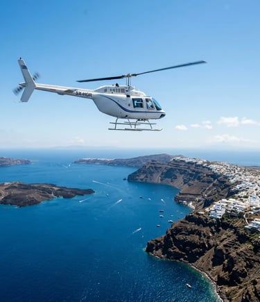 Bell 206 helicopter flying over Santorini volcanic caldera and turquoise Aegean Sea