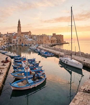 Fishing boats and sailboat docked in Monopoli harbor at golden sunrise
