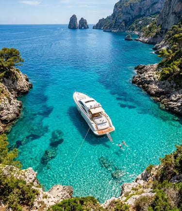Aerial view of modern yacht anchored in turquoise Capri cove with swimmers and ladder