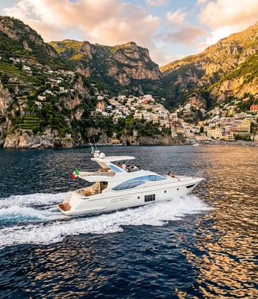 Luxury Azimut yacht cruising along the Amalfi Coast near Positano at golden hour