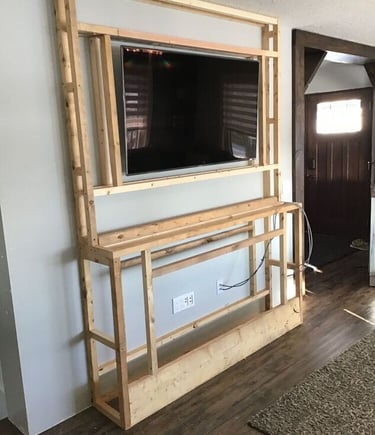 a television screen mounted on a wall in a living room