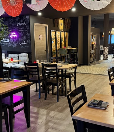 a restaurant with tables and umbrellas and umbrellas