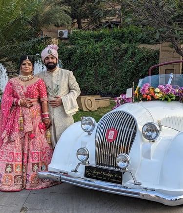 a man and woman in traditional indian attire posing for a photo
