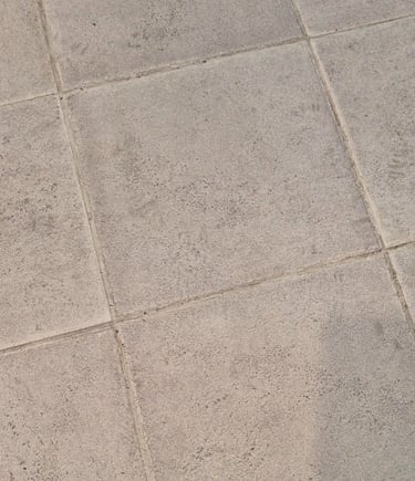 Close-up view of textured grey tiles after laser cleaning