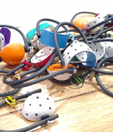 a bunch of different colored earrings on a table