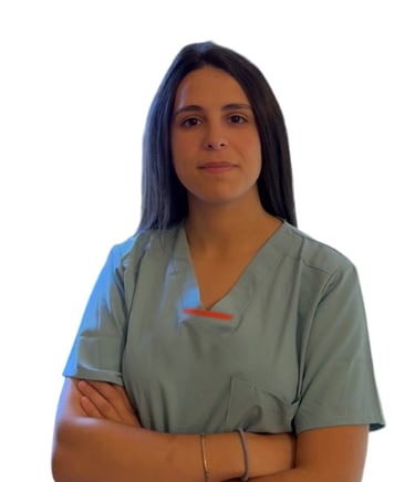 a woman in scrubs and scrubs standing in front of a white wall