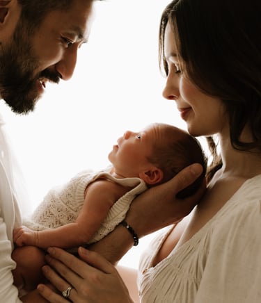 newborn looking up at parents in a newborn studio photo session, Adelaide Hills 