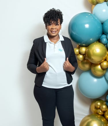 a woman in a black jacket and white shirt stand beside balloon