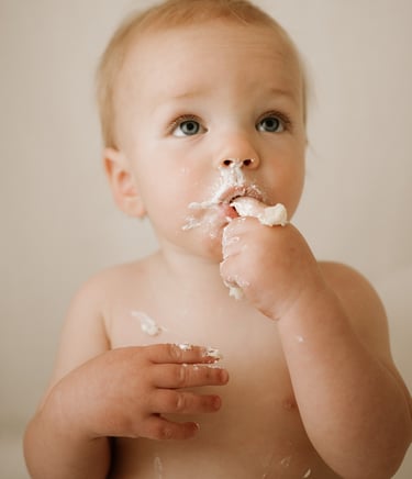 toddler eating cake as part of cake smash photography session in Adelaide