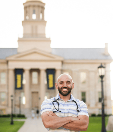 Peter Rosen, FNP with Connected Care NP standing in front of the Old Capitol building in Iowa City