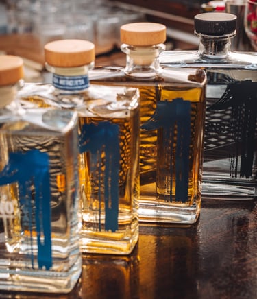four bottles of uno tequila, uno blanco, uno reposado, uno añejo and uno cristalino