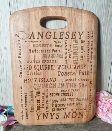 A chopping board with a unique design, the engraving showing Anglesey with things to do and see