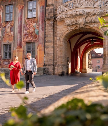 a man and woman walking down a cobblestone path