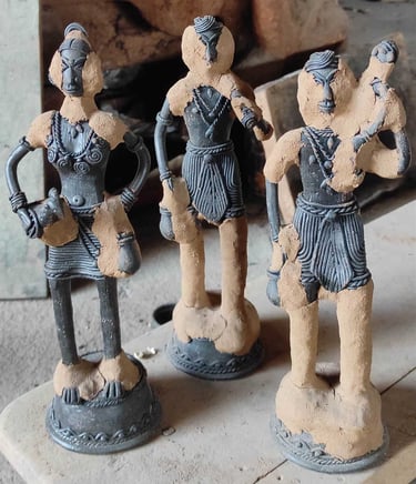 "Applying special clay over wax mould to create brass sculpture in Dhokra art, Bastar Chhattisgarh"