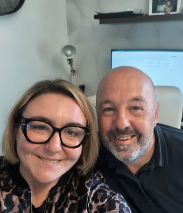 Smiling business colleagues taking a selfie in a modern home office with a computer monitor.